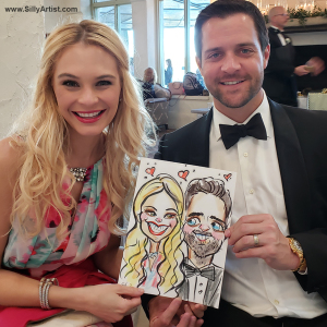 young man and woman holding caricature at austin wedding