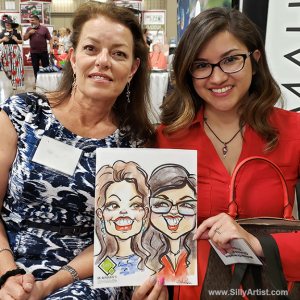 woman holding her trade show caricature in austin silly artist