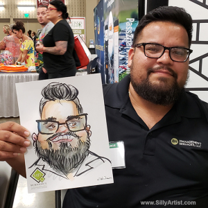 Men holding his funny cartoon at Austin trade show silly artist
