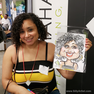 woman holding her trade show caricature in austin silly artist