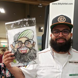 Men holding his funny cartoon at Austin trade show silly artist