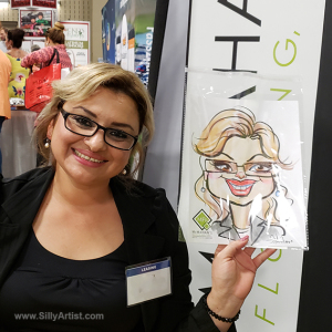 woman holding her trade show caricature in austin silly artist