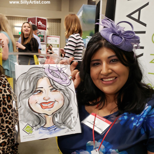 woman holding her trade show caricature in austin silly artist