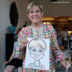 woman holding a caricature at a birthday party in Austin silly artist
