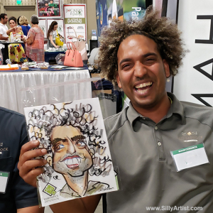man laughing at his caricature at Austin trade show silly artist