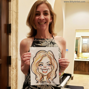 woman holding a caricature at a birthday party in Austin silly artist
